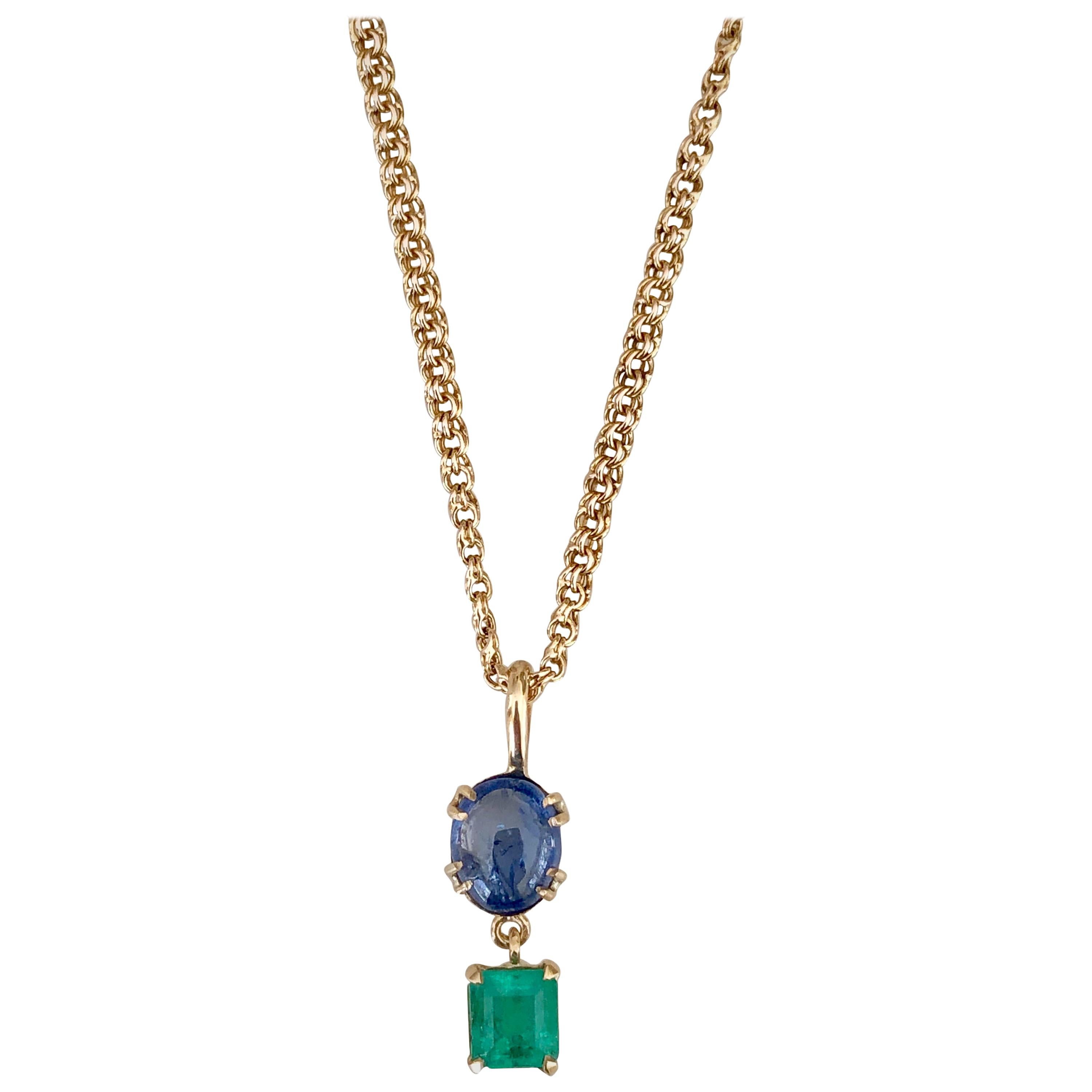 Gorgeous Vintage Pendant Drop Necklace. Natural untreated 4.40 carat Burmese vibrant cornflower blue color sapphire cabochon with emerald cut Colombian emerald approx 1.80 carat, set in 18k yellow gold. The pendant is accompany by a 18.5