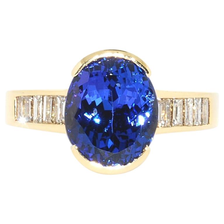 Oval Tanzanite and Diamond Baguette Ring in 14 Karat Yellow Gold For Sale