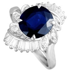 Platinum Round and Tapered Baguette Diamonds and Sapphire Oval Swirl Ring
