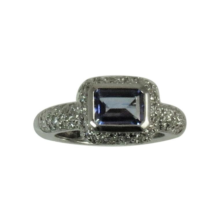 18 Karat Gold Ring Bezel Set with Emerald Cut Tanzanite and Pavé Set Diamonds