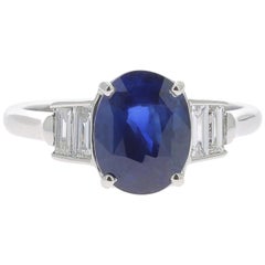 2.26 Carat Oval Intense Blue Sapphire Cocktail Ring Set Baguette White Diamond