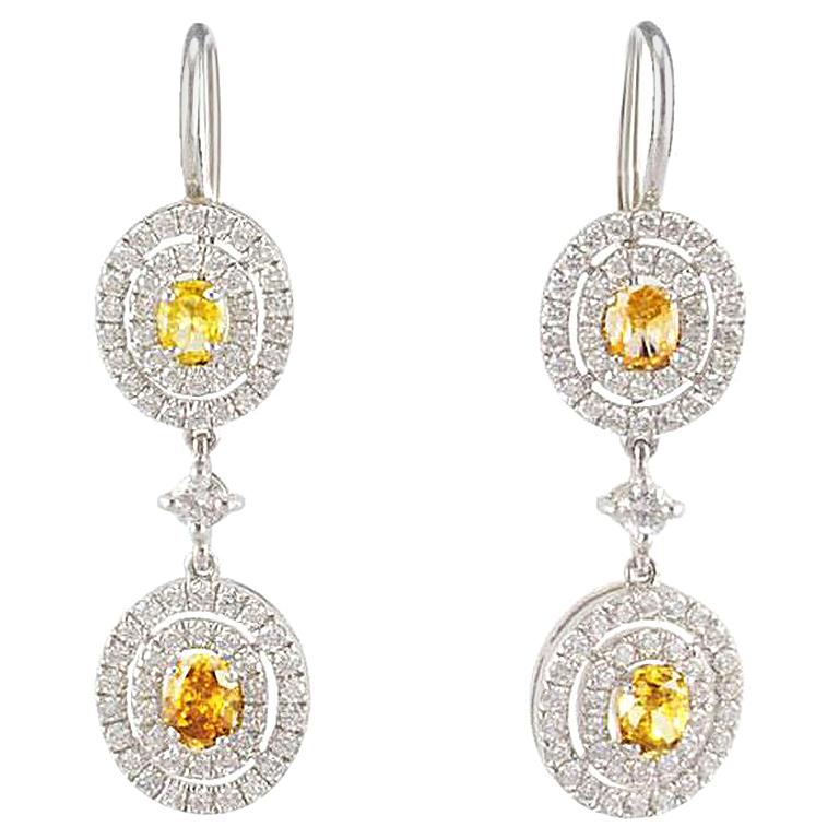 GIA Certified 1.33 Carat Total Oval Fancy Yellow Diamond Dangle Earrings