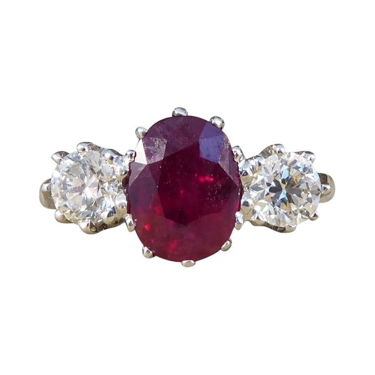 Oval Ruby and Diamond Three-Stone Engagement Ring in Platinum