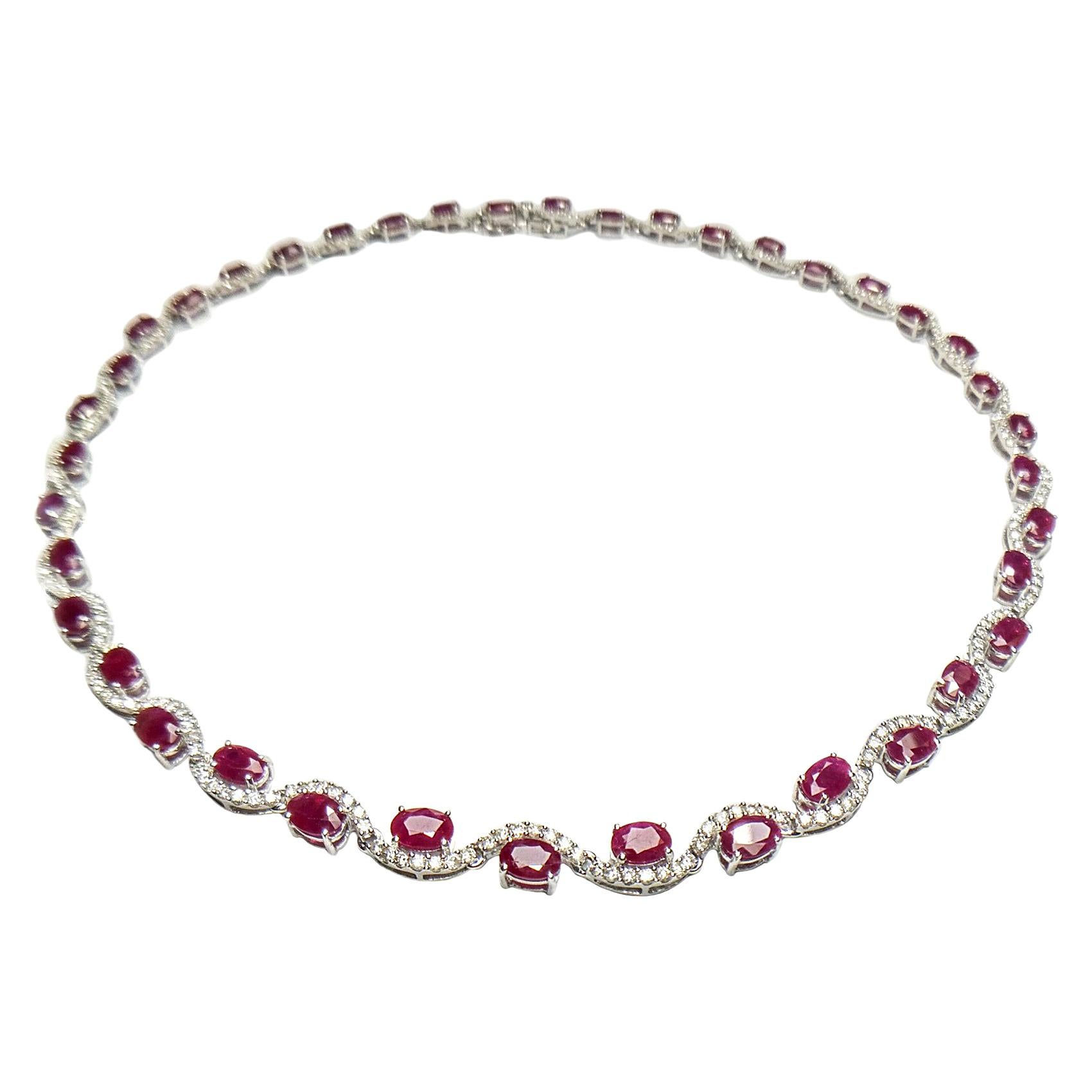 Red oval ruby and diamond necklace. Beautiful handcrafted swirl design necklace, accented with lively red oval natural rubies encased in open mount set in 4 prongs with round brilliant cut diamonds, assembled in 14 karats white gold with hinged