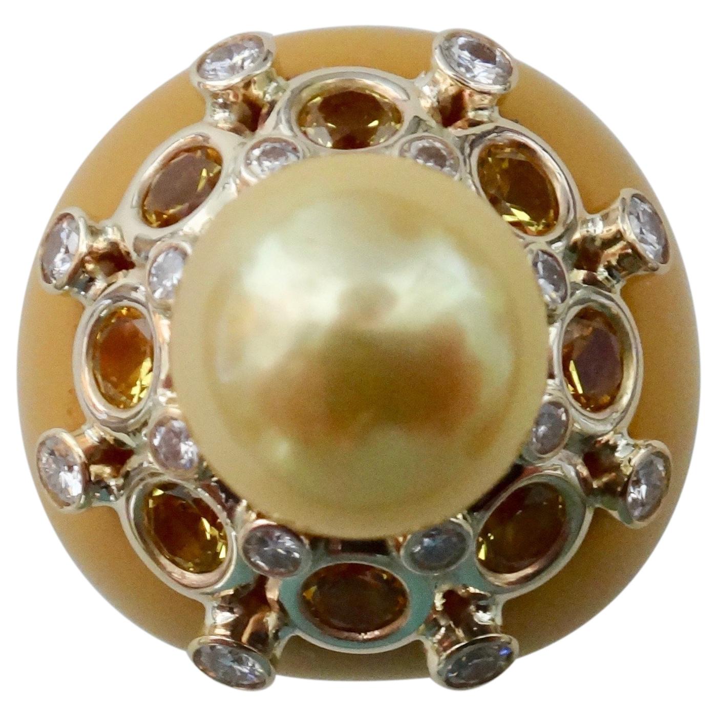 A vintage Bakelite dome ring forms the foundation of this dynamic cocktail ring.  The dome has been topped with a golden South Seas pearl (origin: Australia) which is surrounded by eight brilliant cut yellow sapphires (origin: Sri Lanka) and sixteen