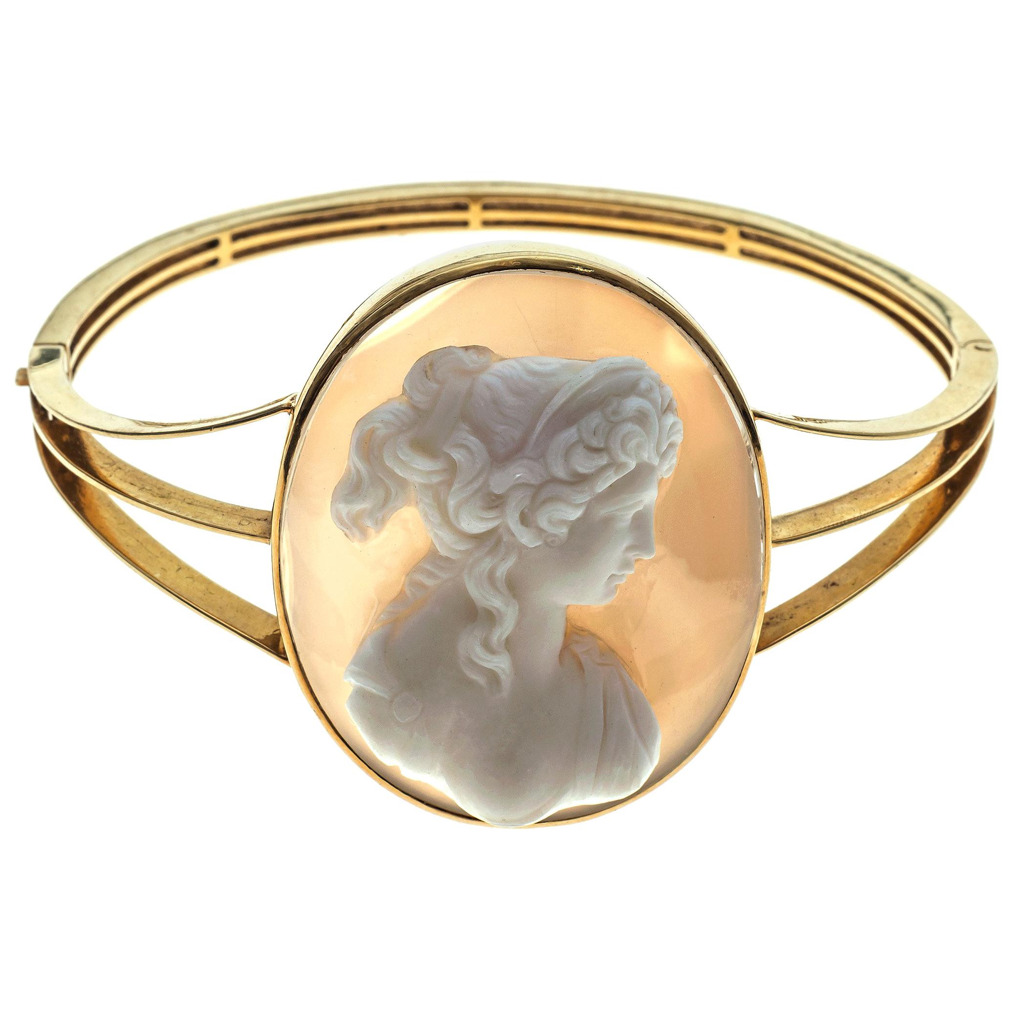 Carved agate cameo of a mythological female bust in profile. The oval sard cameo has been mounted in an 18K gold bangle in 1880's.

size bangle: 6,2 cm (W) x 4,6 cm (L)
size cameo: 4,2 cm (L) x 3,3 cm (W) the