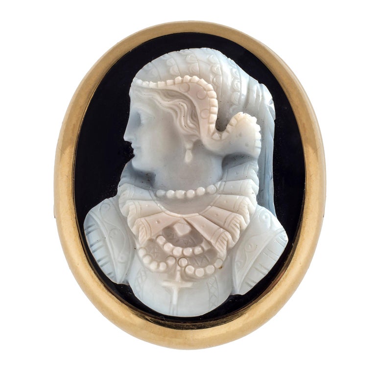 Sardonyx cameo brooch and earrings with a profile bust of Maria Stuart. The attributes of Maria Stuart are consistent with renaissance fashion seen in period paintings of her. Fine carving dating from about 1870-1880. The demi parure has been worked