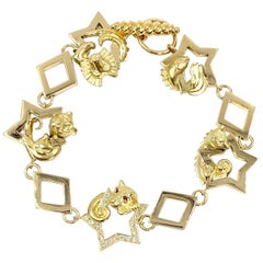 18 Karat Vintage Star Animal Charm Bracelet with Diamonds and Rubies