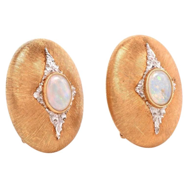 These classically distinct clip-back Vintage Buccellati earrings are crafted in finely textured 18K yellow gold. Designed as alluring oval plaques, they are centered with a pair of enchanting opal oval cabochons, cumulatively weighing 1.50cts. Set