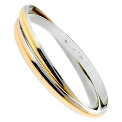 Cartier Gold-Edelstahl-Armreif mit ineinandergreifendem Cartier