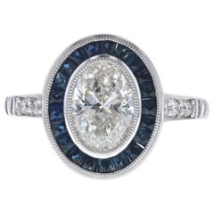 Vintage Inspired Oval Diamond Engagement Ring with Blue Sapphires