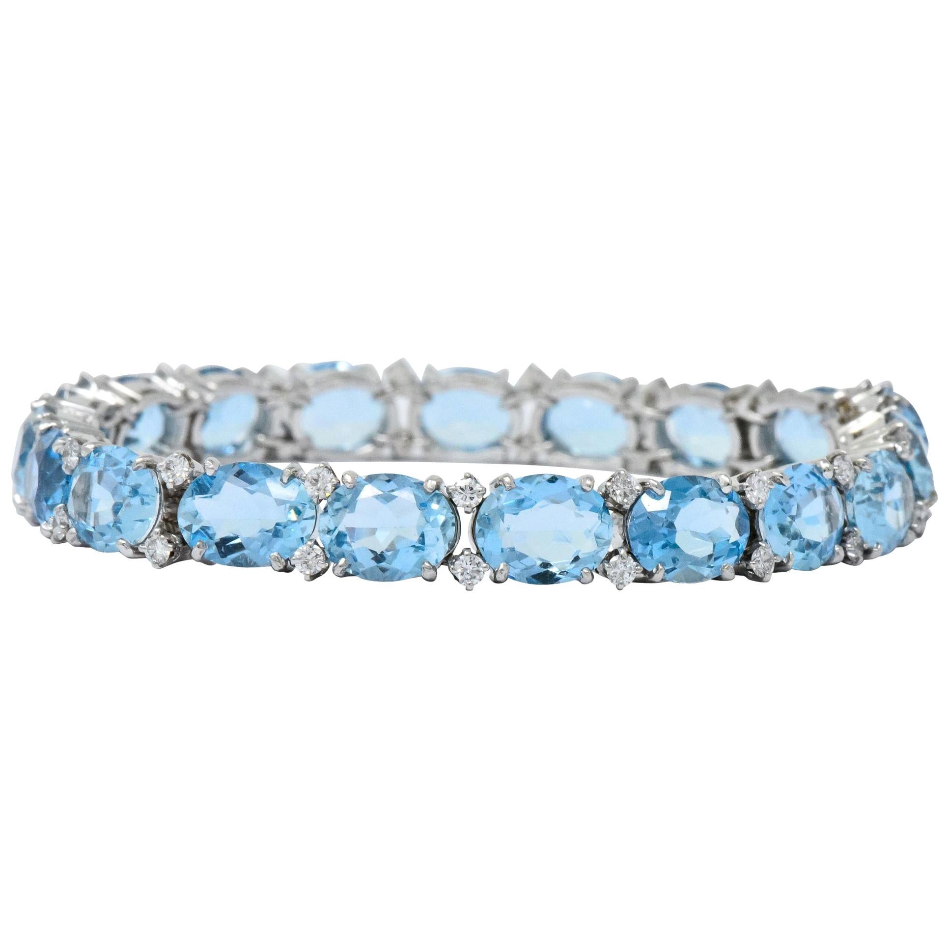 Each link centering faceted oval aquamarine weighing approximately 28.43 carats total

Cool blue color, eye-clean, and very well matched

Accented by round brilliant cut diamonds weighing approximately 1.15 carats total, G/H VS1

Completed by