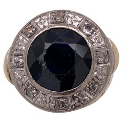 Two-Tone Gold Ring Diamonds Flanking a Sapphire