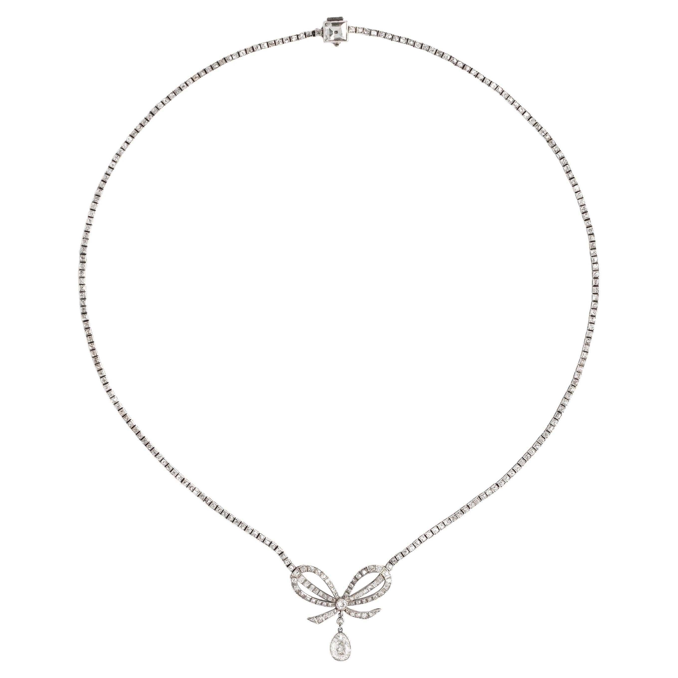 Belle Epoque Diamond Platinum Bow Pendant Necklace.
In our opinion we estimate the old mine cut pear shape diamond weights around 1.30/1.60 carat,
The square cut diamond on the clasp weights around 0.80/1.10 carat. The remaining diamonds weight