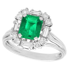 1970s 1.43 Carat Emerald and Diamond Platinum Cluster Ring