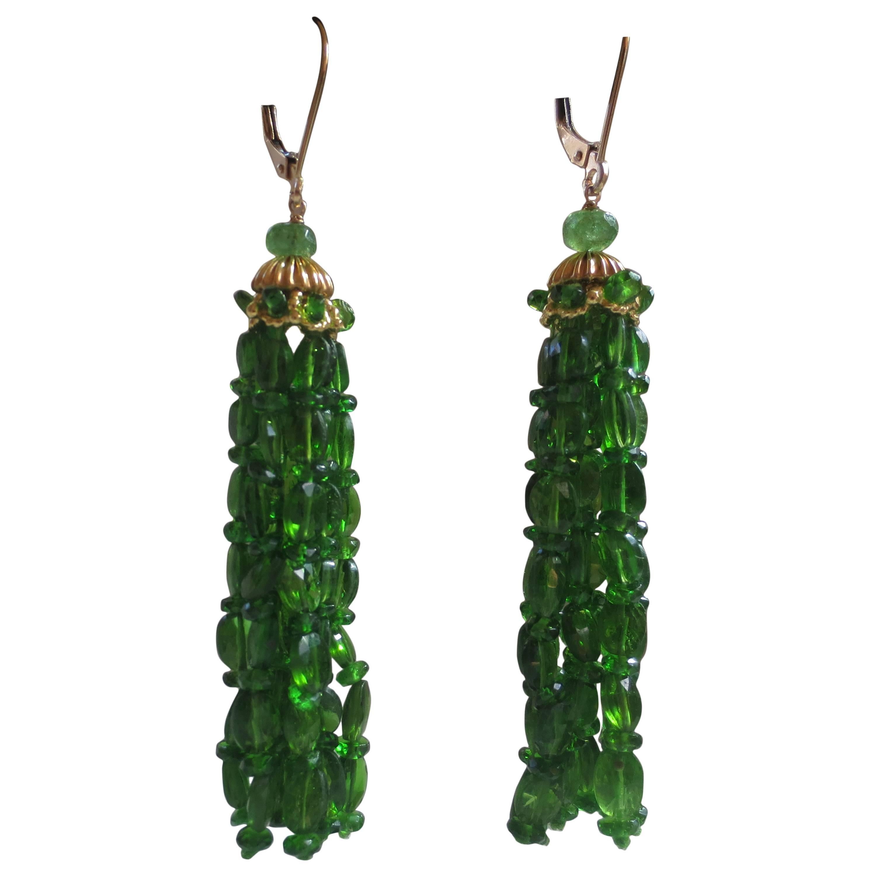 These elegant tassel earrings by Marina J, are topped by a round tsavorite bead and a unique 14 karat gold piece, through which are threaded strands of translucent tsavorite beads. The ear wires are also 14 karat gold.  These 3-inch tassel earrings