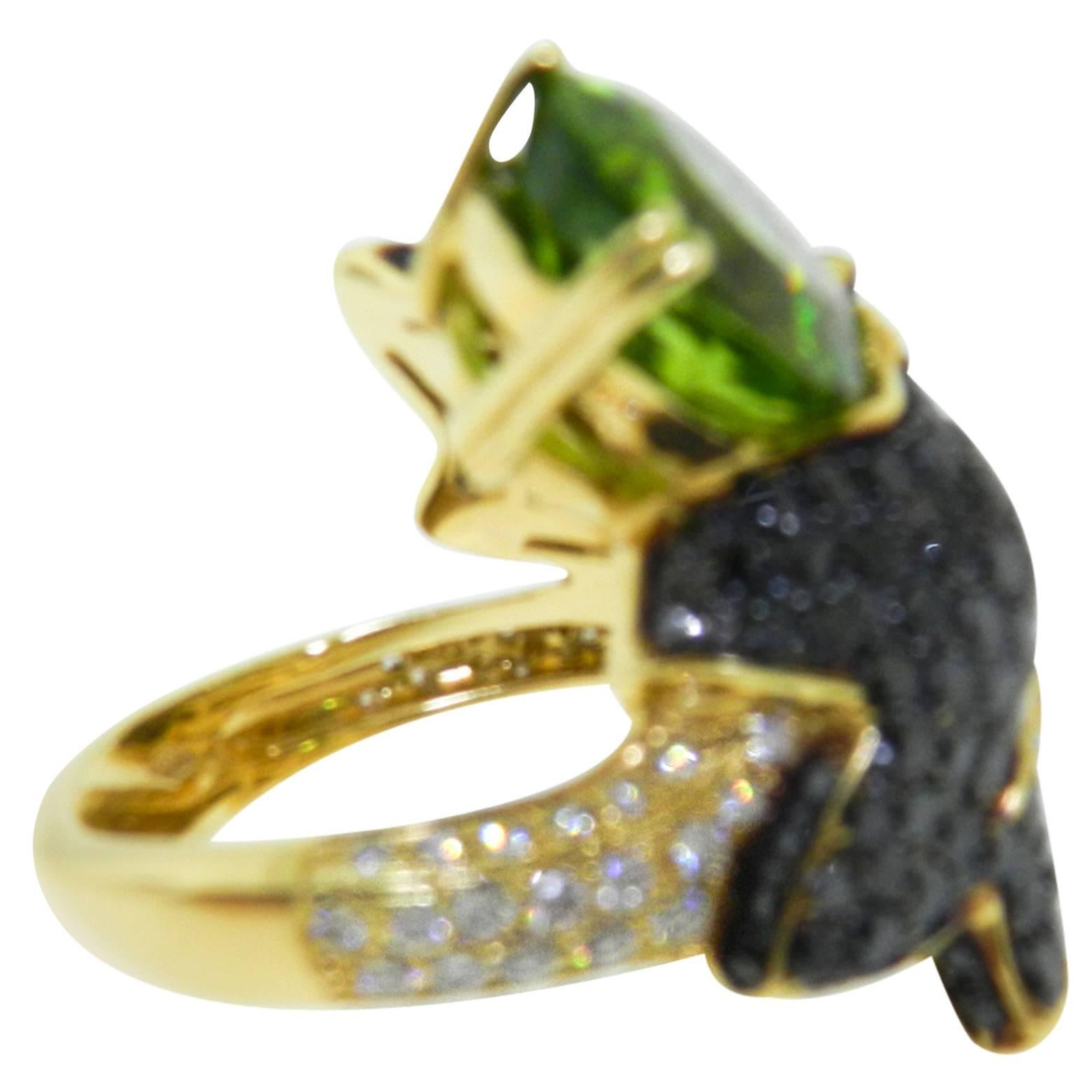 Stunning Cocktail ring, centering an oval-shaped peridot weighing approximately 1.40 carats, with a black pave diamond leaves, with a pavé-set white diamond style band, the diamonds altogether weighing approximately 0.74 total carats, mounted in
