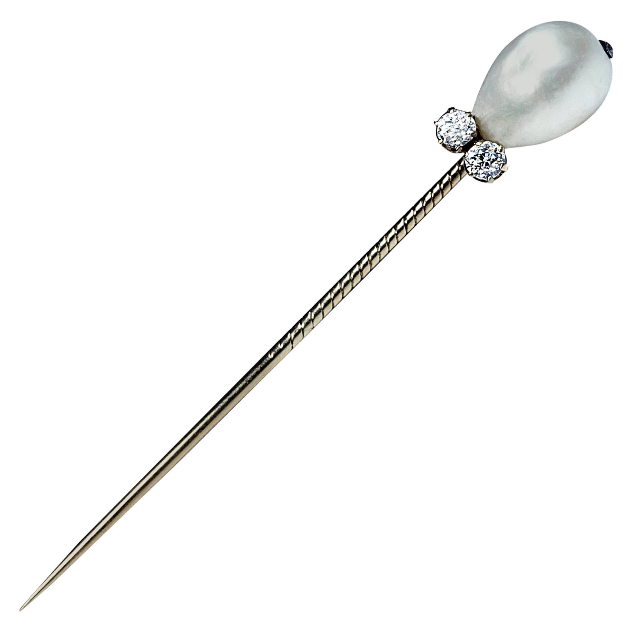 by Carl Faberge, made in St. Petersburg between 1882 and 1898

The 14K gold stickpin features a large drop shaped natural saltwater pearl (approximately 12.8 mm long) accented by two old European cut diamonds (estimated total diamond weight 0.30
