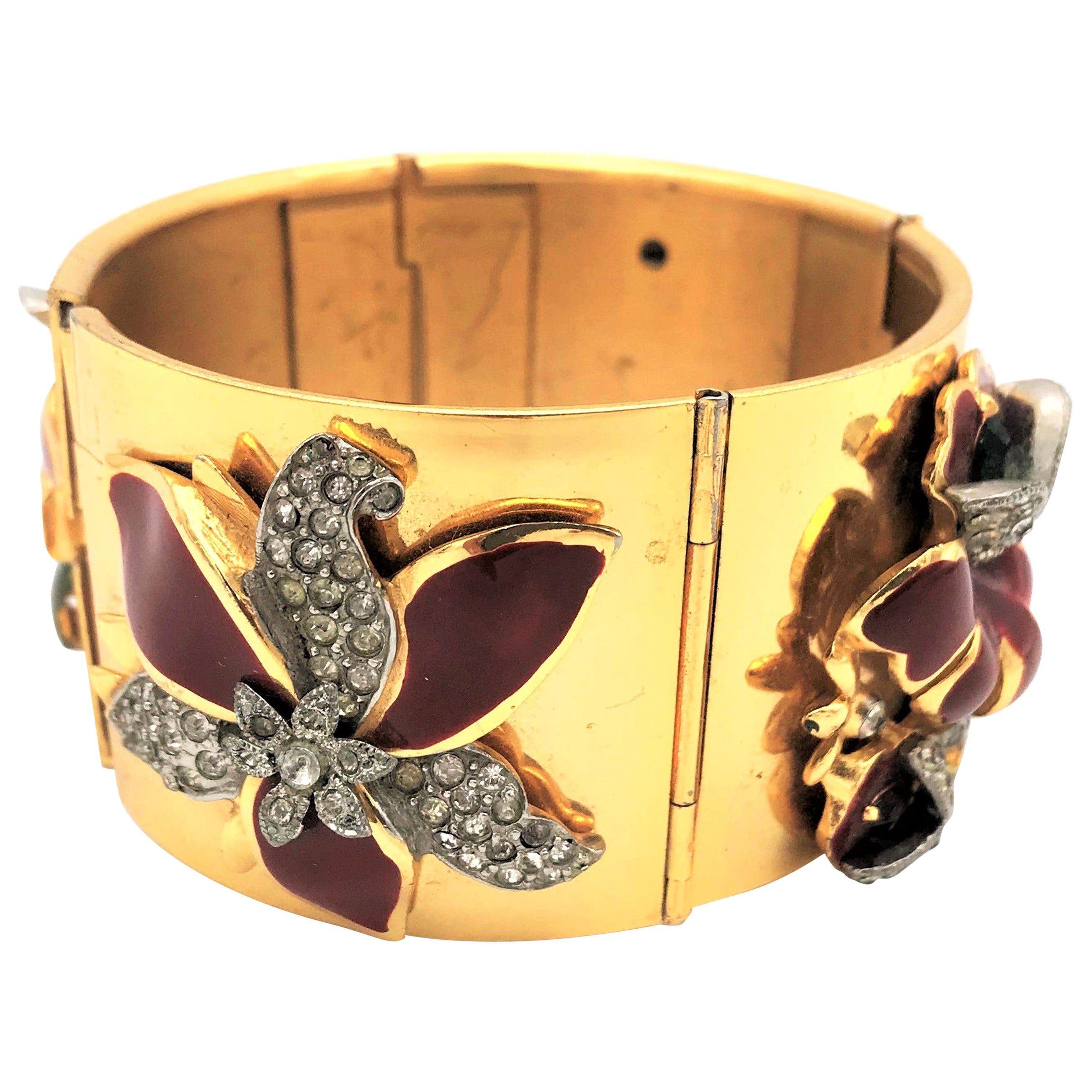 Gold plated hinged bracelet with Coro enamel flowers attached from the 1940s   For Sale
