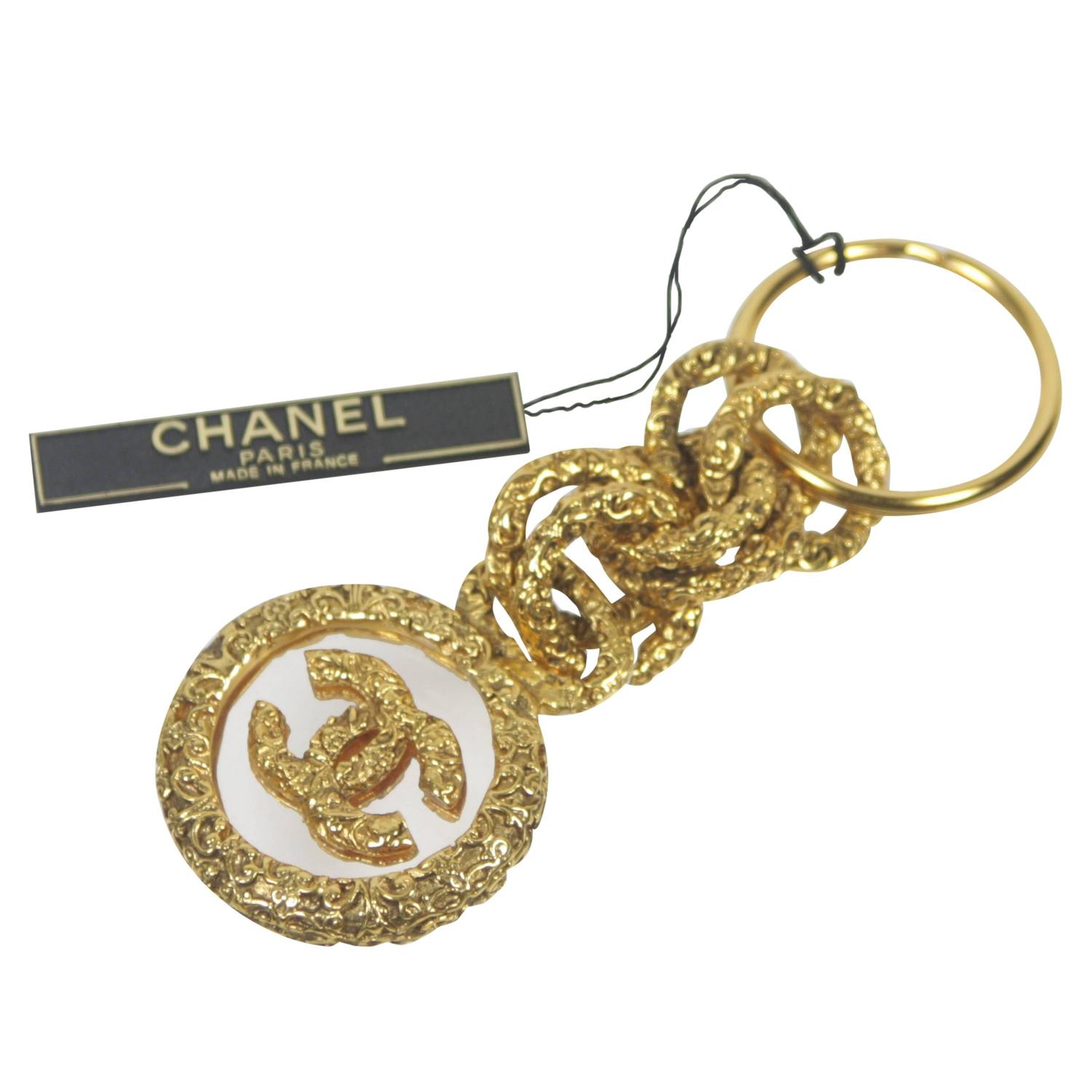 Chanel Gold Tone Textured Charm Key Ring Logo Set in Glass New with