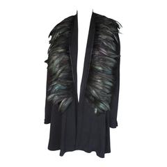 black draped evening jacket with an Iridescent feathers collar