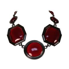 YVES SAINT LAURENT numbered bronze 
ruby red lucite necklace