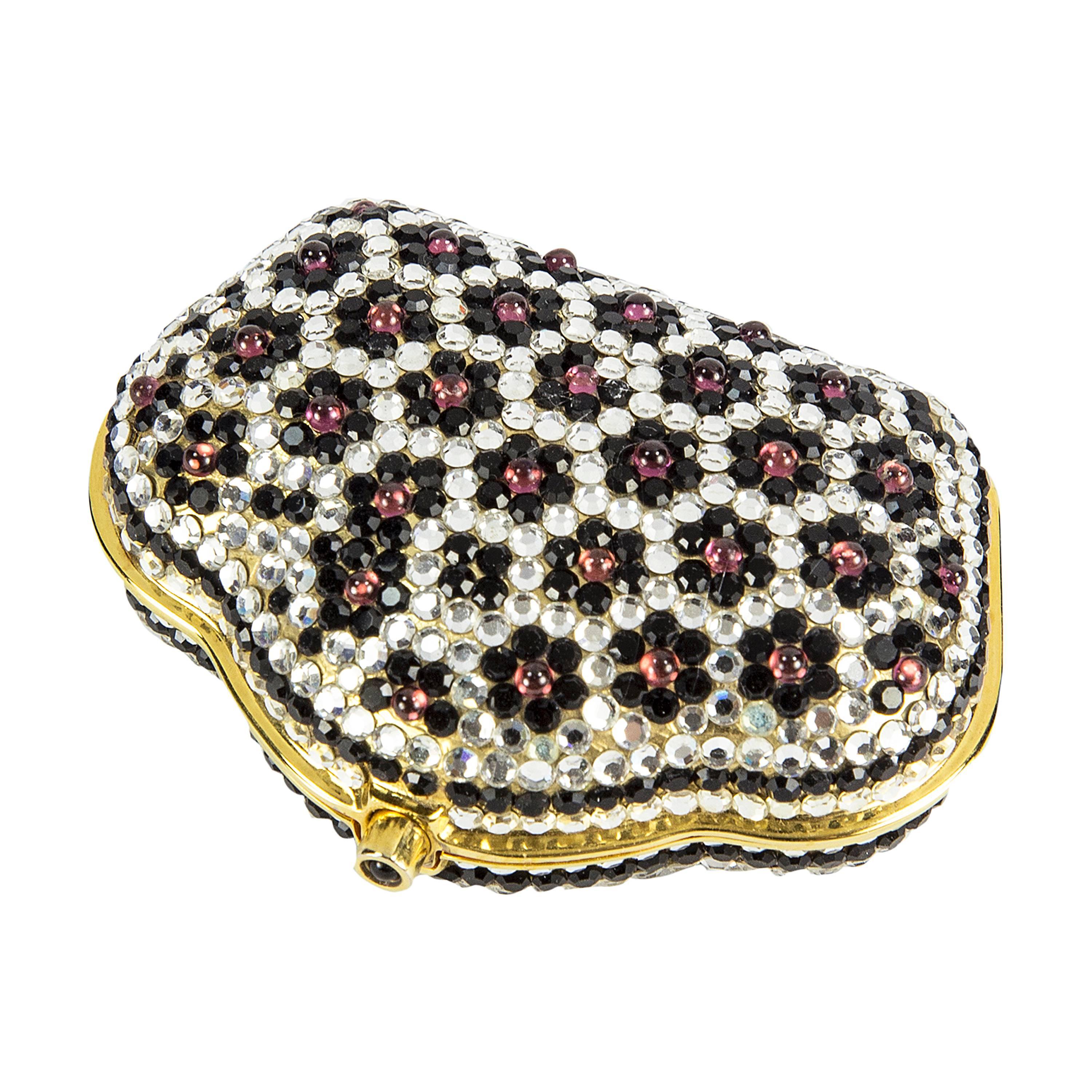 Must Have Trinket or Pill Box encrusted with Swarovski Crystals in Black, Silver and Pinkish Red stones. Signed: Judith Leiber on the inside. Approx. size: 2.65” wide x 1.90” high x .75” deep. Never used. Add a little magic to the everyday! 
