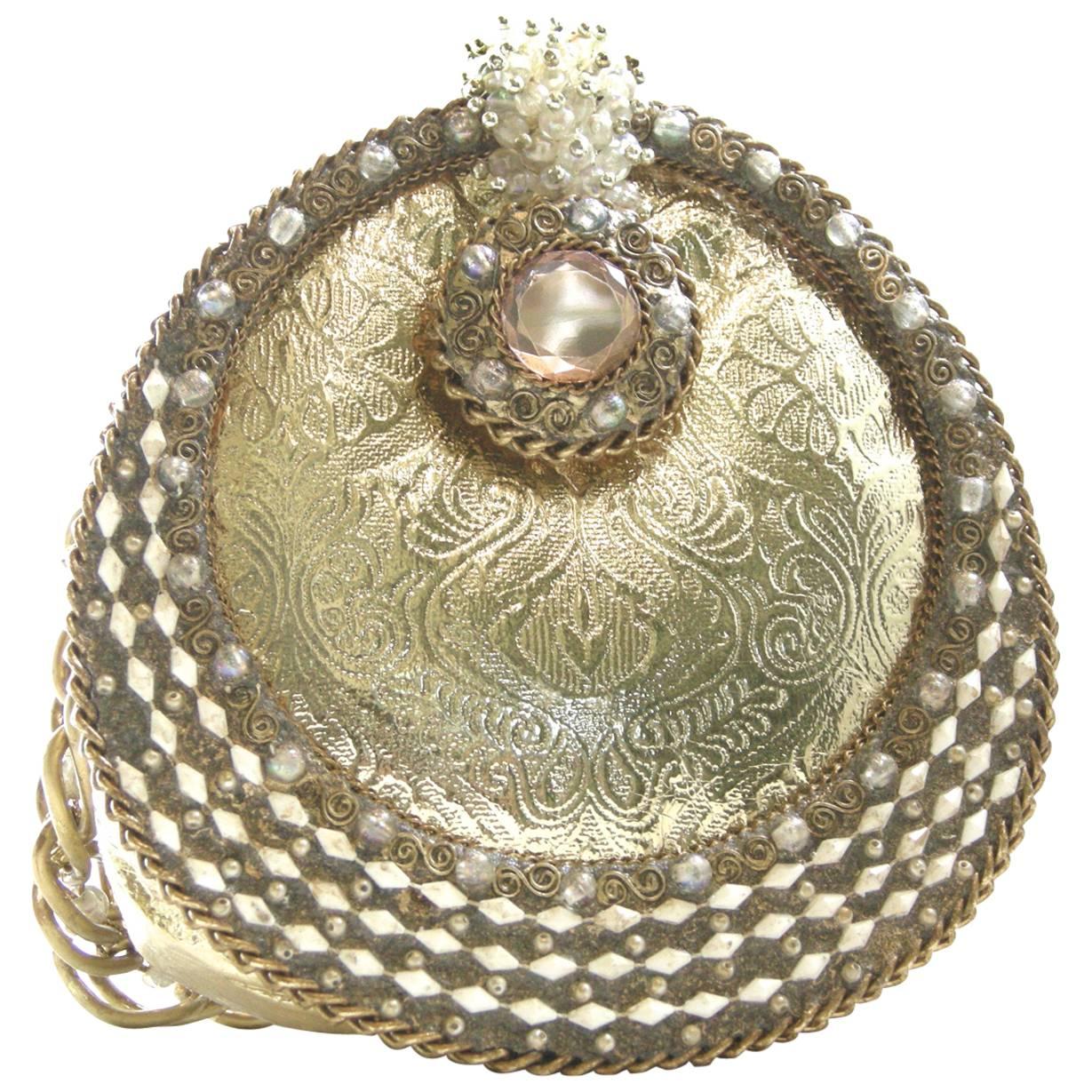 Mary Francis purses are very popular and collectible.   I consider this one of her special purses.   This exquisite gold leather and bead encrusted evening bag has a large faux pink topaz gemstone on the flap with white faux coral shells. The bag
