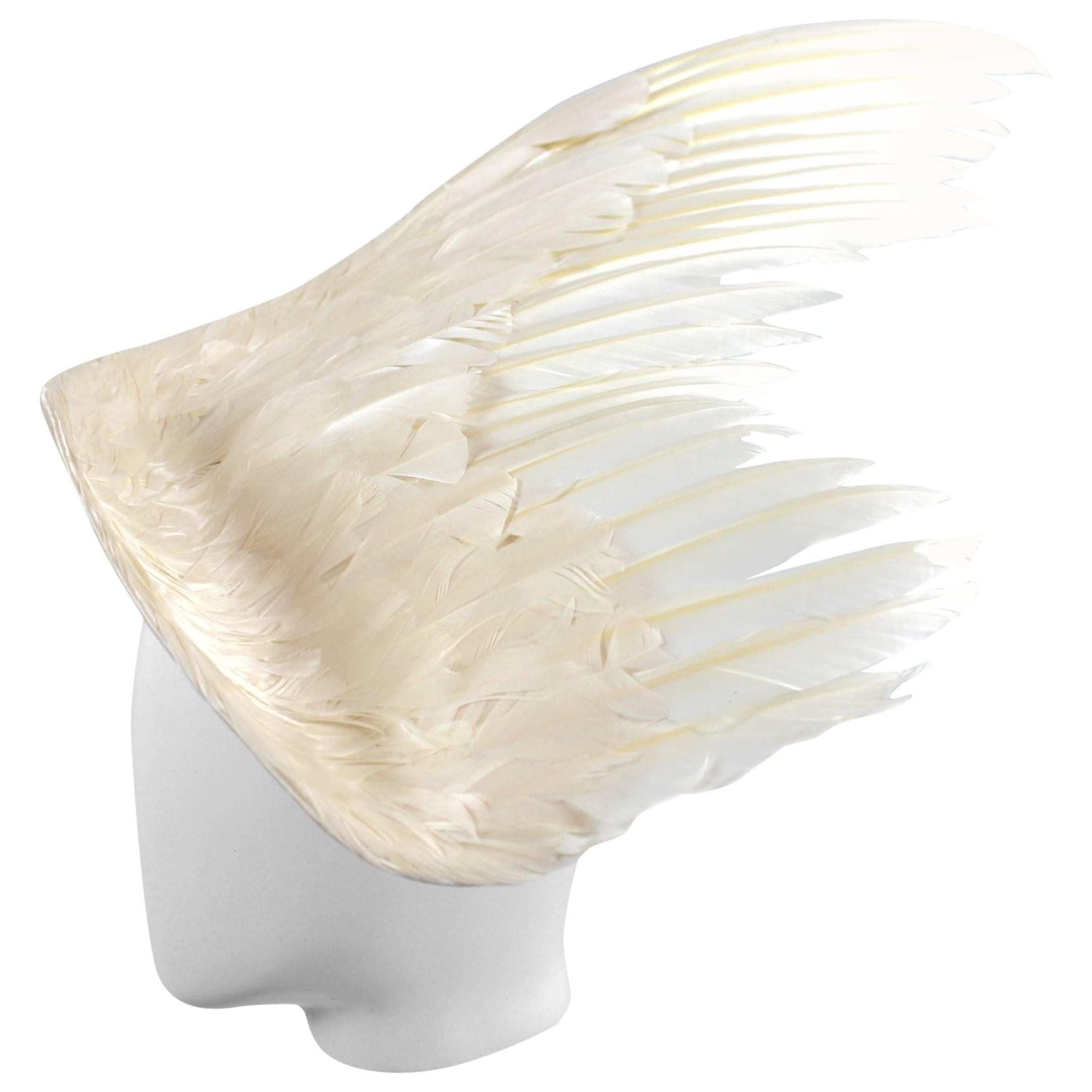 Stephen Jones Feather Runway way hat Circa 1990
White Satin Wing shape covered in White Feathers
22 inch Wingspan
