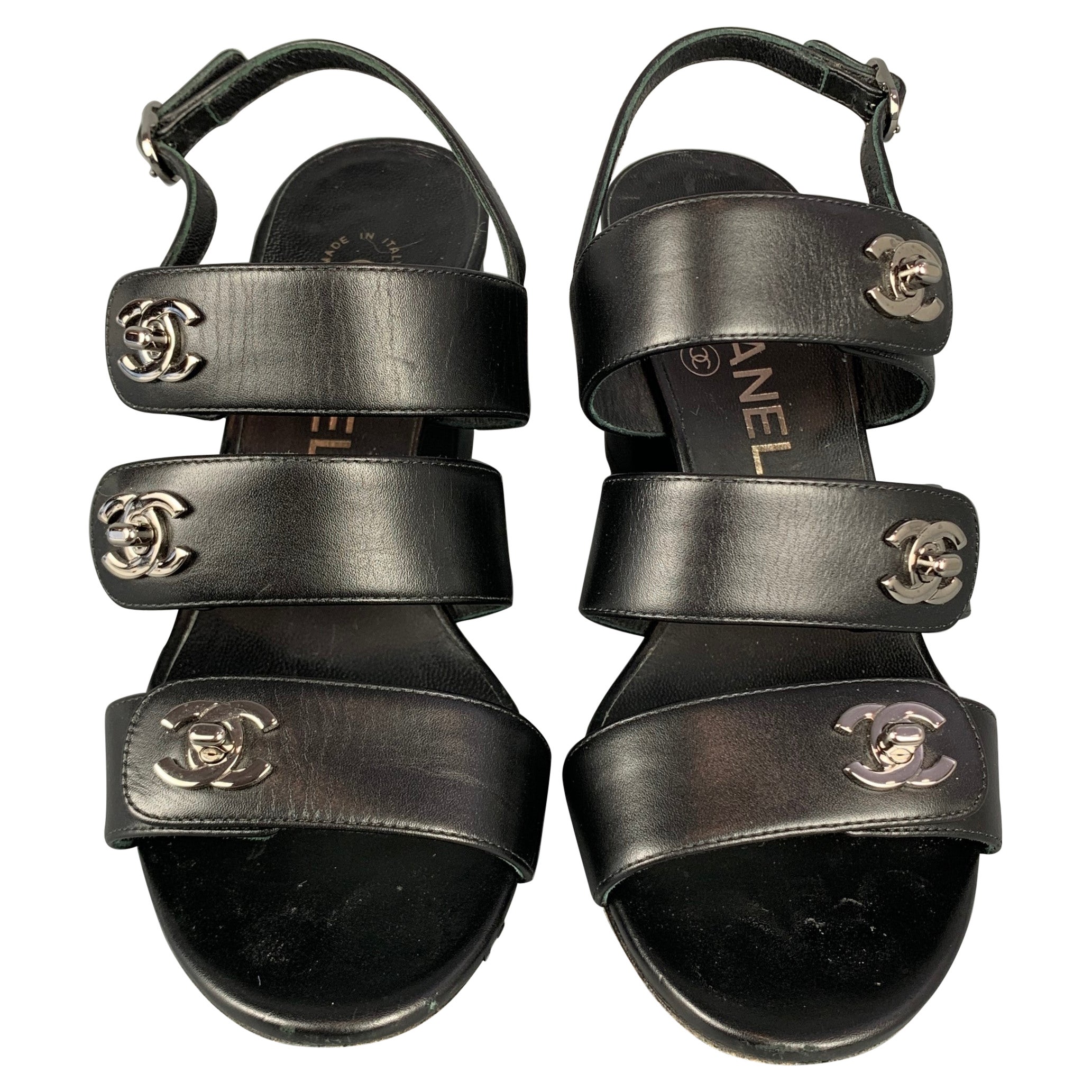CHANEL Size 6 Black & Silver Leather Turn Lock Logo Chunky Heel Sandals