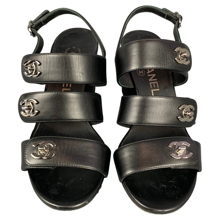 CHANEL Size 6 Black and Silver Leather Turn Lock Logo Chunky Heel Sandals