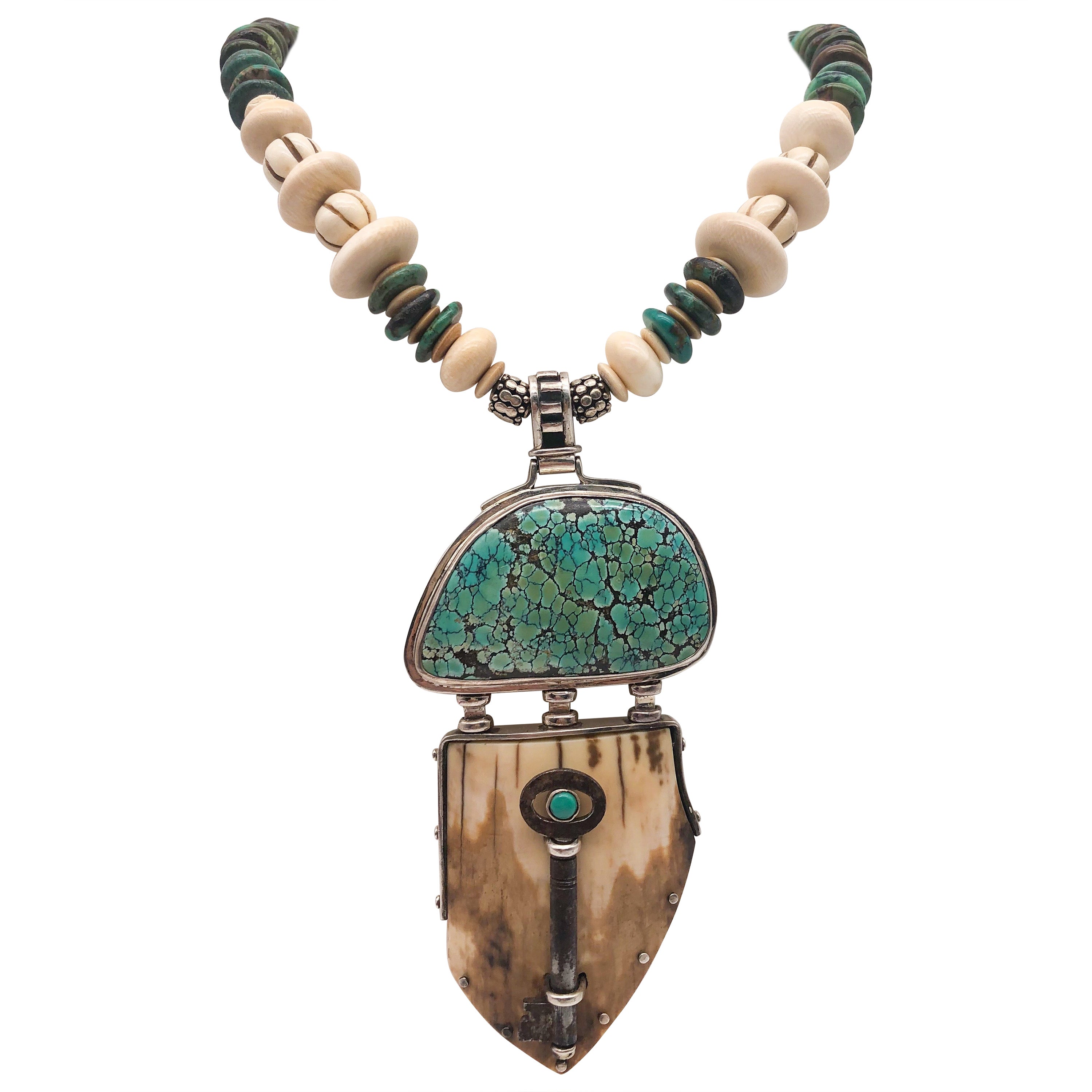 One-of-a-Kind
Edward Lawrence designed a glorious pendant from prehistoric fossils walrus collected by the First Nation people of St. Lawrence Island. The fossil is crowned by a similarly shaped and polished half-moon of Carico Lake Turquoise