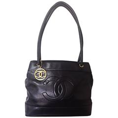 Vintage CHANEL black classic tote bag in nappa leather with gold tone CC charm