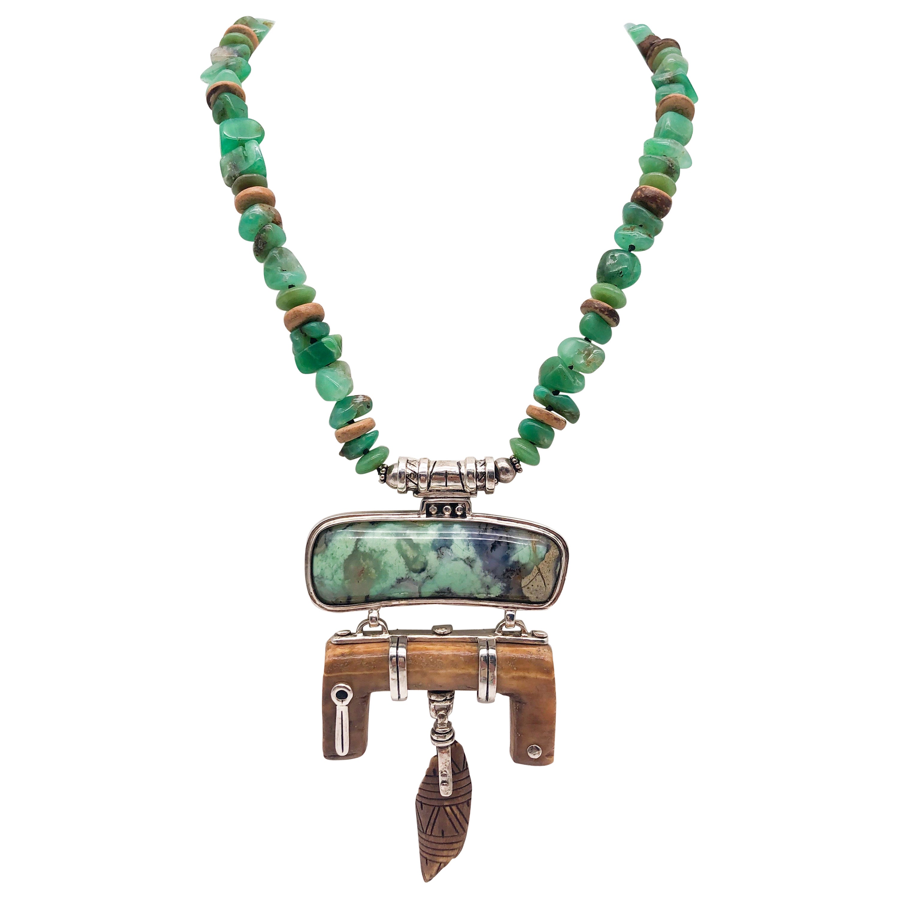 A.Jeschel Carved Fossil Pendant suspendend from a rich green Chrysoprase stones For Sale