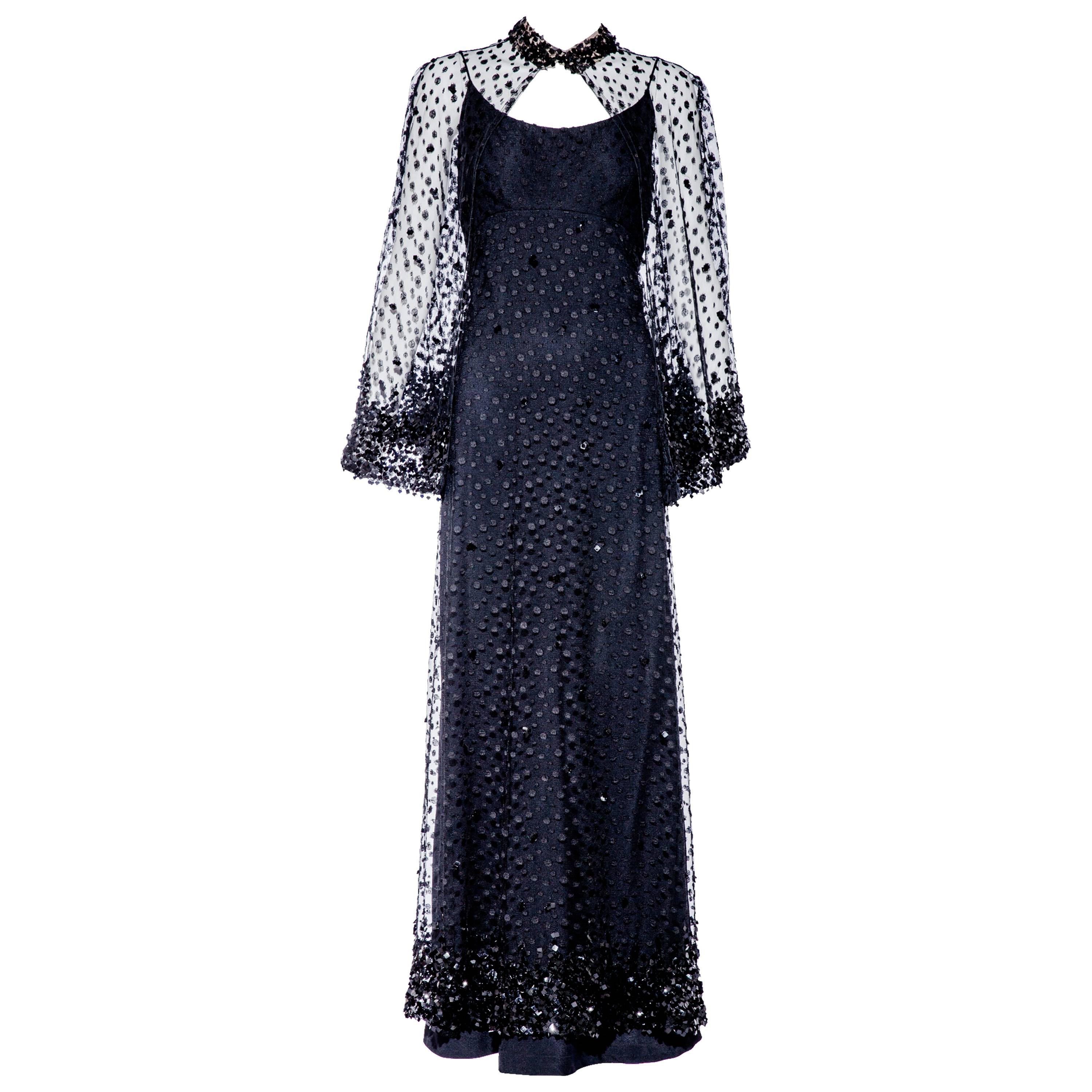 1970s Alfred Bosand black lace gown with capelet
