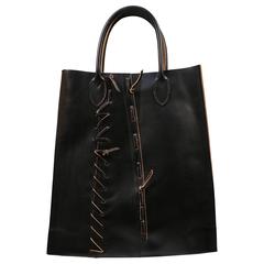 COMME DES GARCONS black leather bag with hand woven saddle stitching