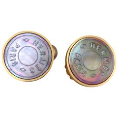 MINT. Vintage HERMES golden logo embossed genuine shell earrings. 