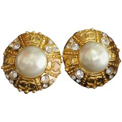 Vintage CHANEL gold tone round earrings with faux pearl, crystal stones, and CC