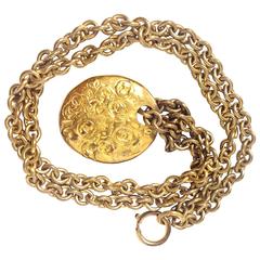 Vintage CHANEL gold tone long chain necklace with a round coin, medal cc top