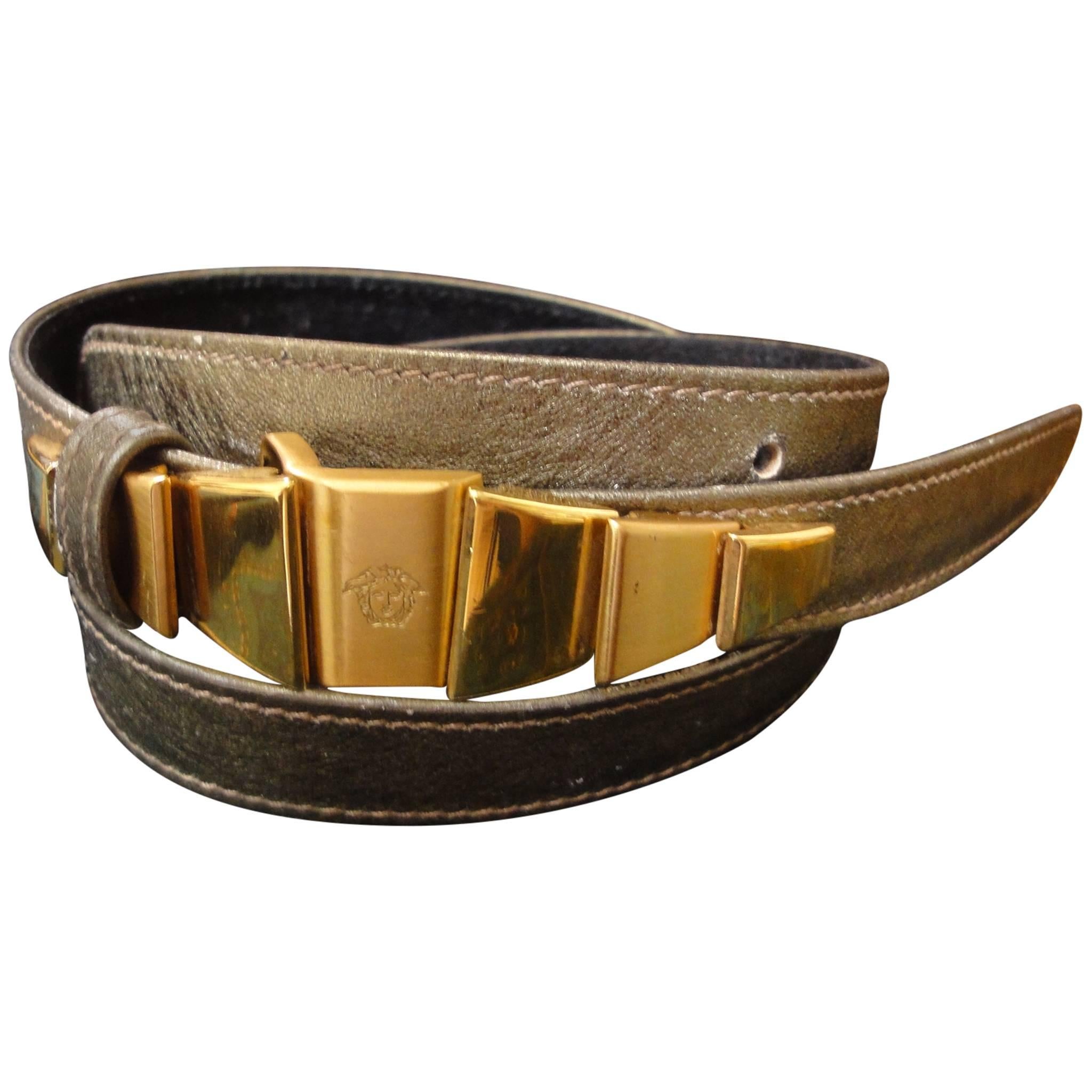 Vintage Gianni Versace skinny gold bronze leather belt with golden hardware  For Sale