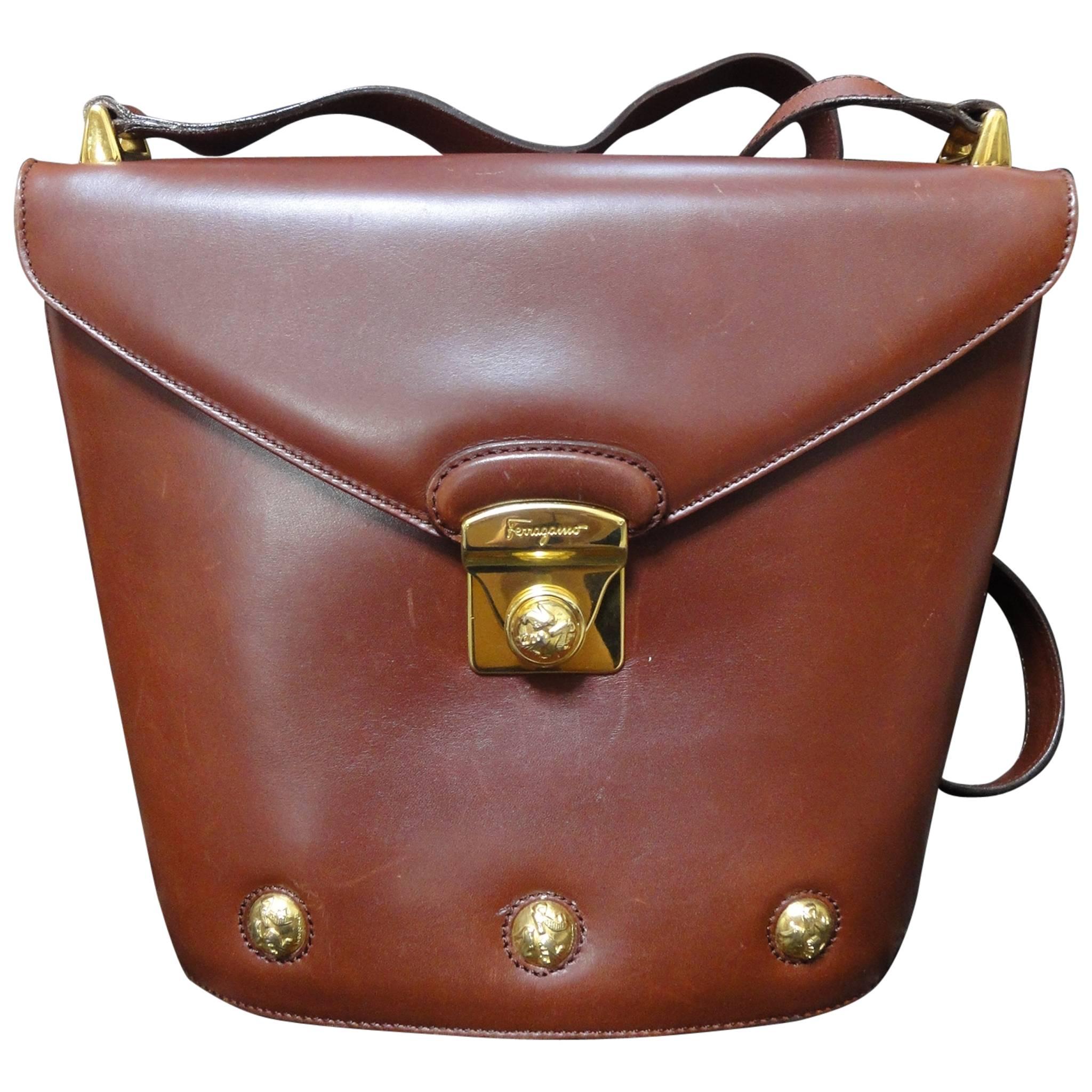 Vintage Salvatore Ferragamo brown leather trapezoidal shape purse with motifs.