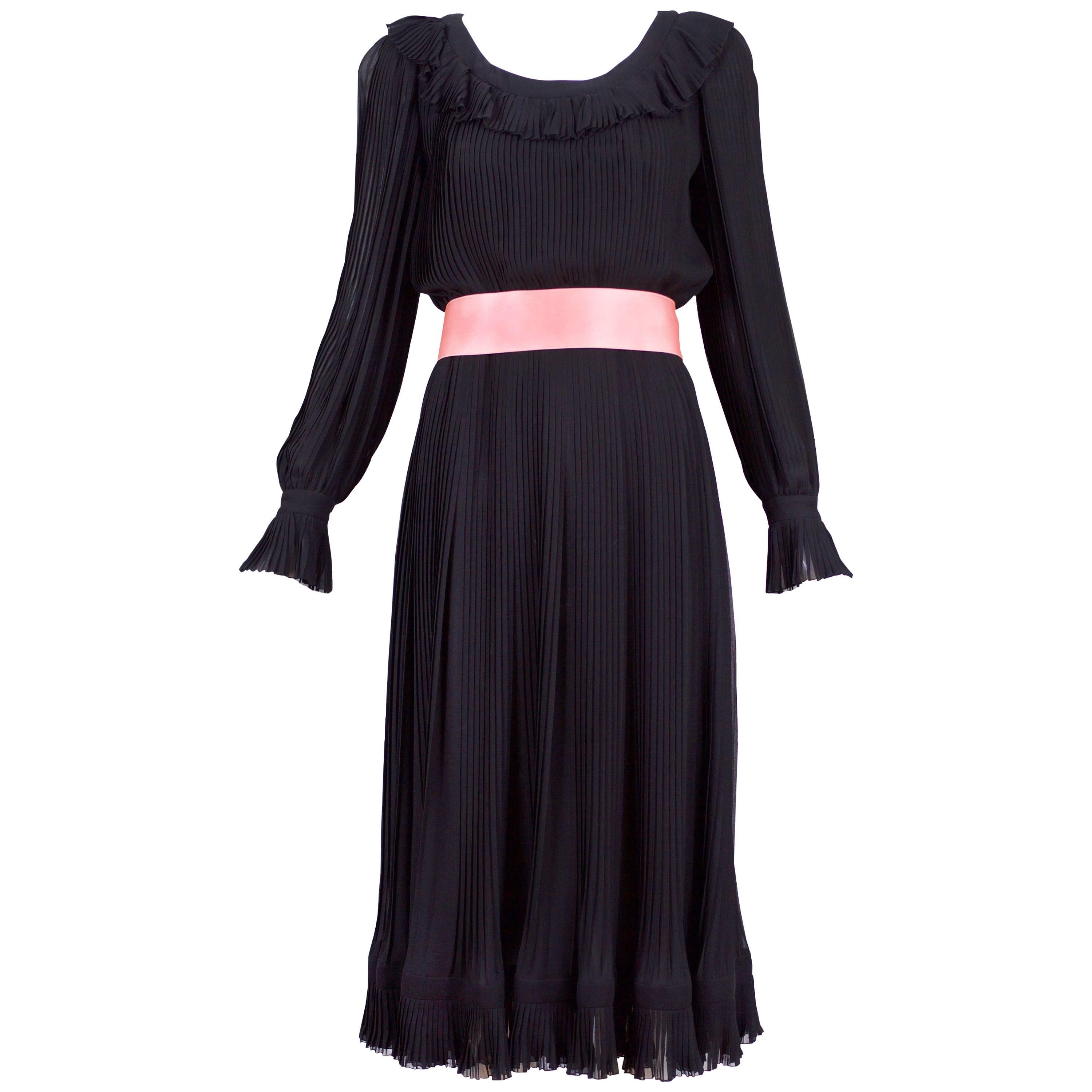 1974 A/H Christian Dior haute couture black silk chiffon pleated dress with ruffled neck, sleeves and hem. Comes with pink silk self tie belt - unsure if belt is original. No size tag so please consult measurements.
MEASUREMENTS:
Bust - 34