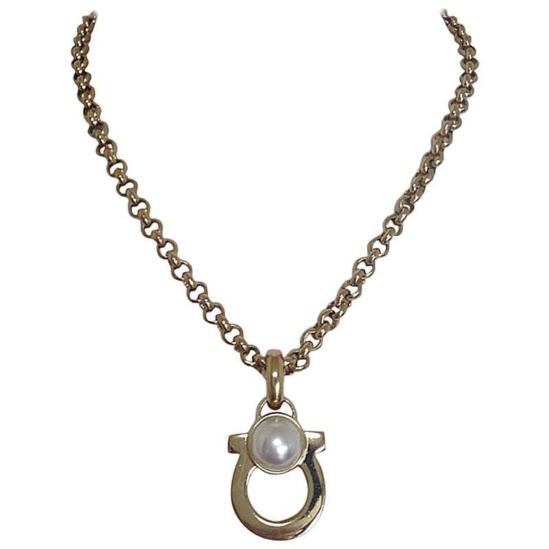 Vintage Salvatore Ferragamo white faux pearl and golden gancini necklace. For Sale