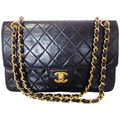 1980's vintage Chanel black 2.55 classic double flap bag with golden chain strap