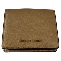 Used Micheal Kors gold leather wallet
