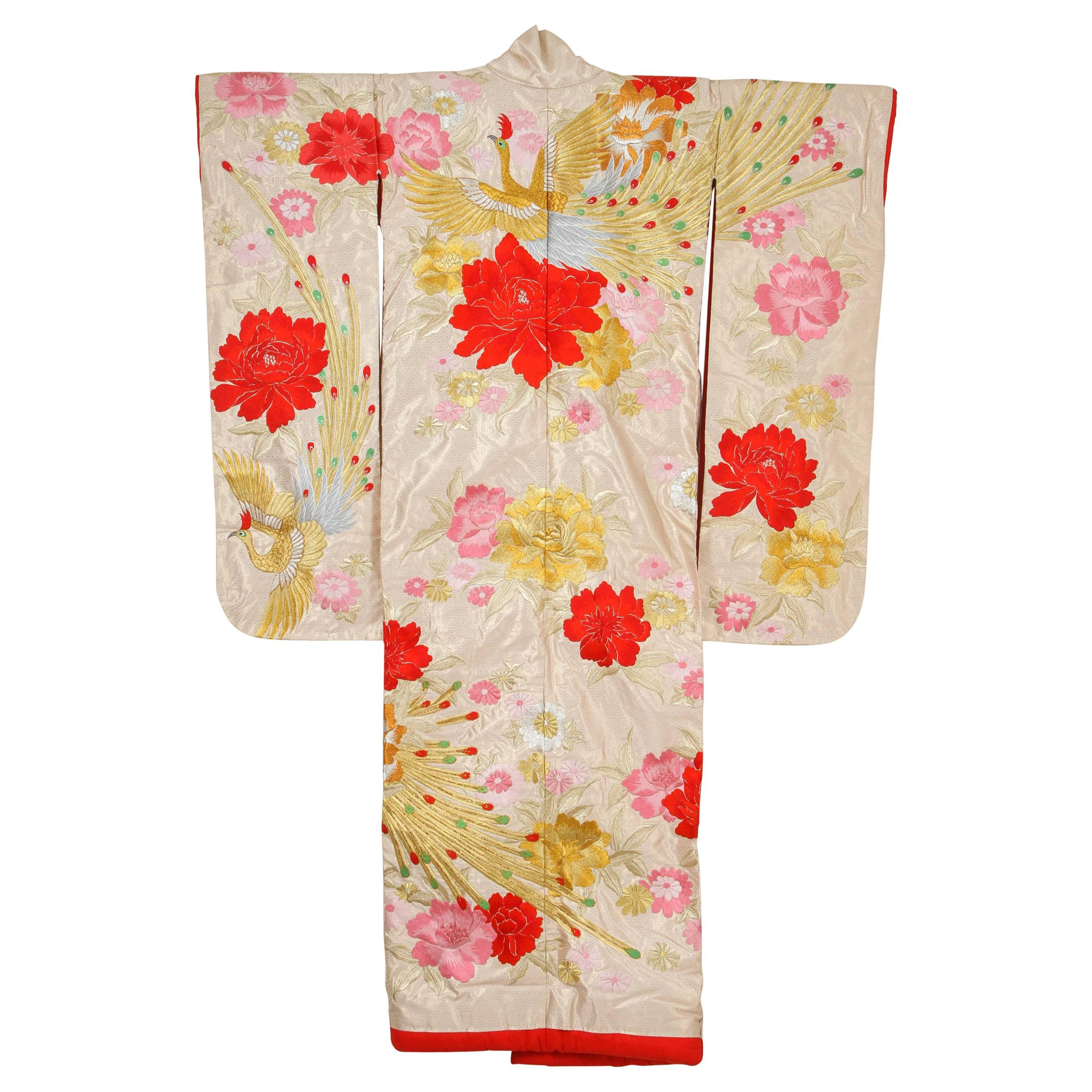 A vintage Mid-Century ivory color silk brocade collectable Japanese ceremonial kimono. One of a kind hand crafted.
Fabulous museum quality ceremonial piece in pure silk with intricate detailed hand-embroidery throughout accented with floral gold