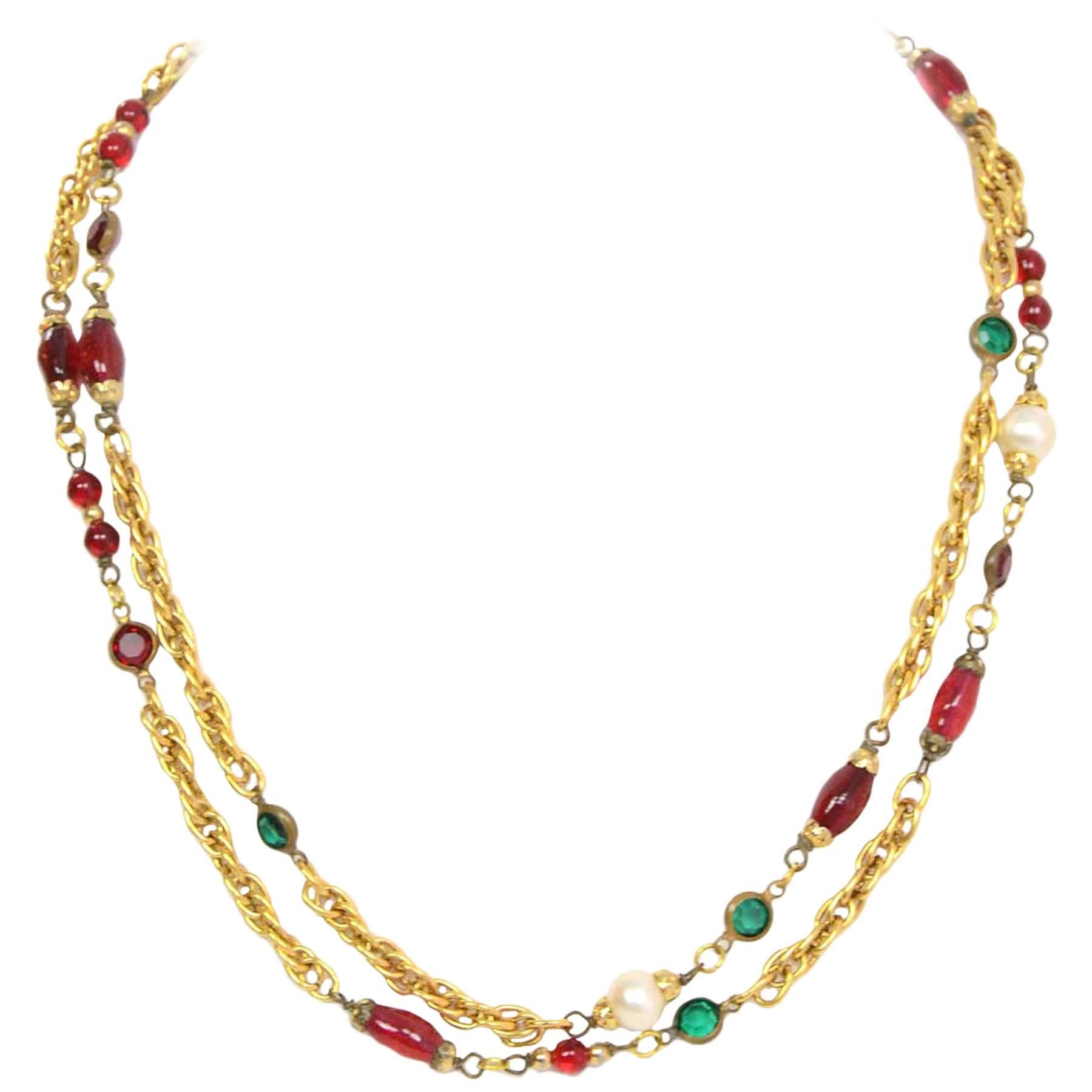 Chanel Gripoix & Pearl Long Strand Necklace
Features red gripoix, red and green crystals and faux pearls throughout
Made in: France
Year of Production: 1984
Color: Red, green, ivory and goldtone
Materials: Strass crystals, gripoix, metal,