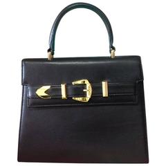 Used Gianni Versace black leather Kelly style bag with golden buckle closure 