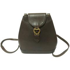 Retro MOSCHINO dark brown leather backpack with golden and black M logo.