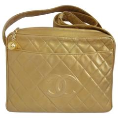 Vintage CHANEL golden lamb leather shoulder bag with CC mark and cc charm.